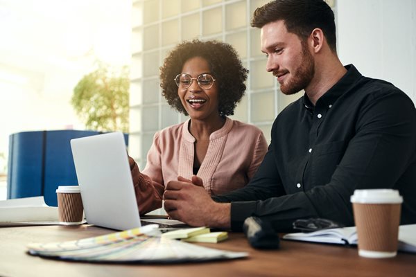 Woman and man working together in meeting.