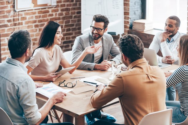 Happy employees having a meeting at a table